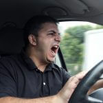 Tips for Protecting Yourself in a Road Rage Situation Guy Driving Honking Yelling