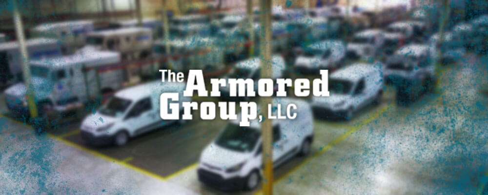 The Armored Group LLC Front Page Front Page Warehouse Multiple Vans Trucks Background