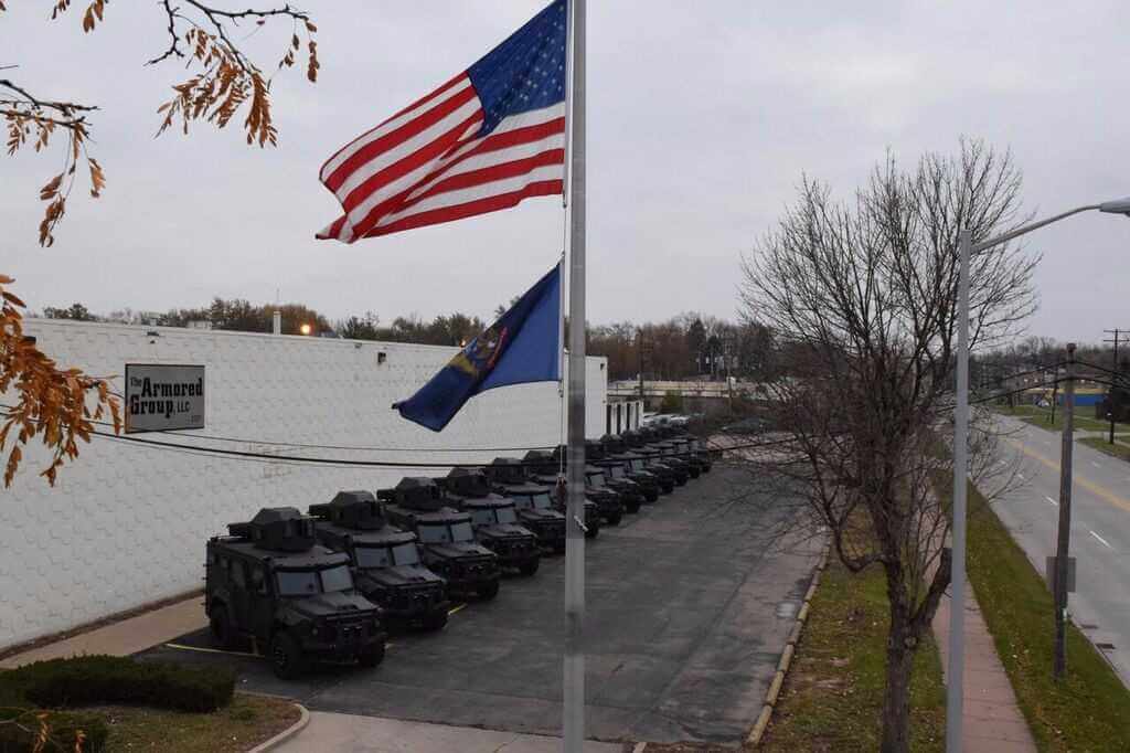 TAG APCs With Flag Line Armored Trucks Outdoors