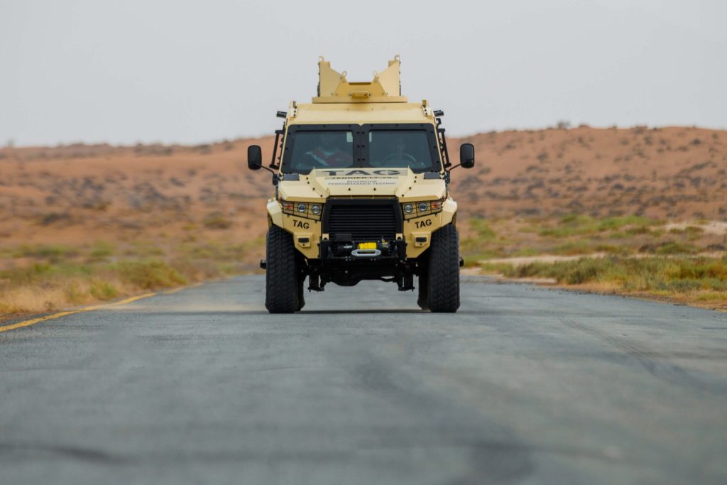 Armored car on desert road from The Armored Group